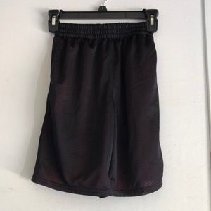 Black athletic shorts with red accent